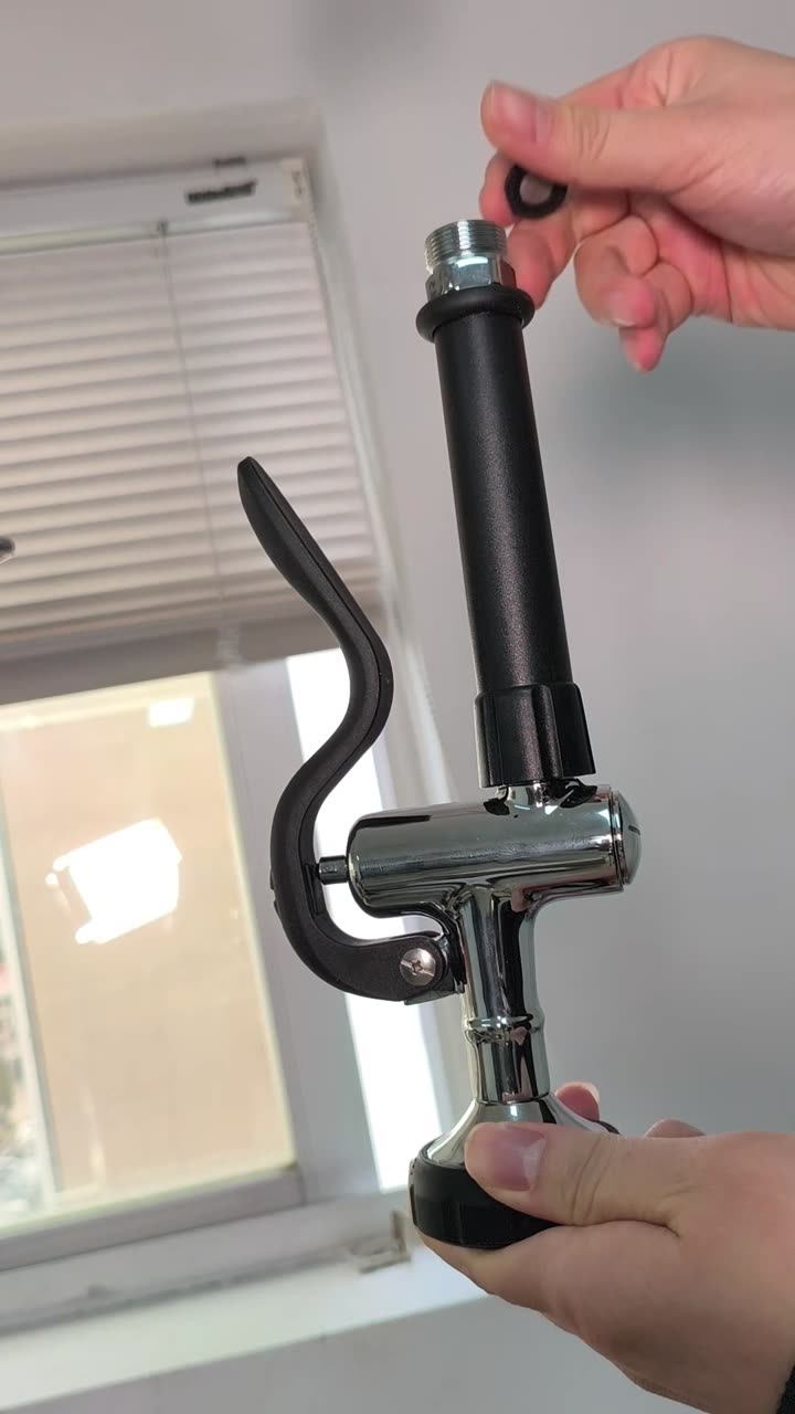 The spray head threading back onto the hose, an O-ring held ready